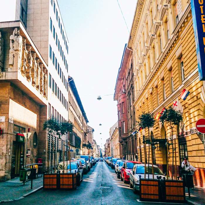 Old European Street with Buildings and Cars