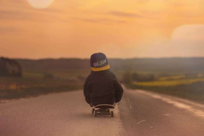 Boy on skateboard at sunset 4K