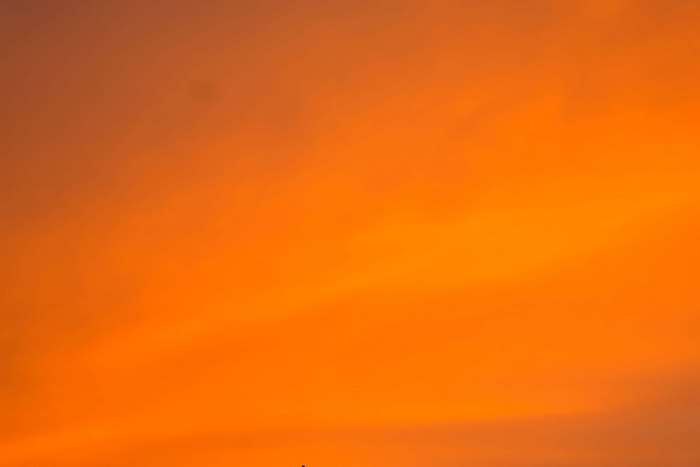 Orange sunset sky with clouds