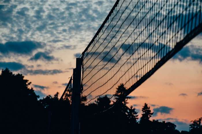 Sunset Beach Volleyball Net with Colorful Sky