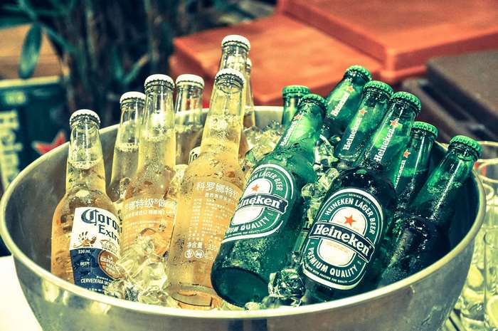 Heineken and Corona beer bottles in a bucket