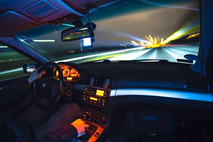 Car driving at night on a blurred road