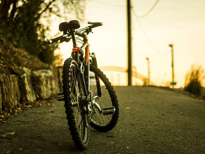 Mountain bike on a paved path at sunset