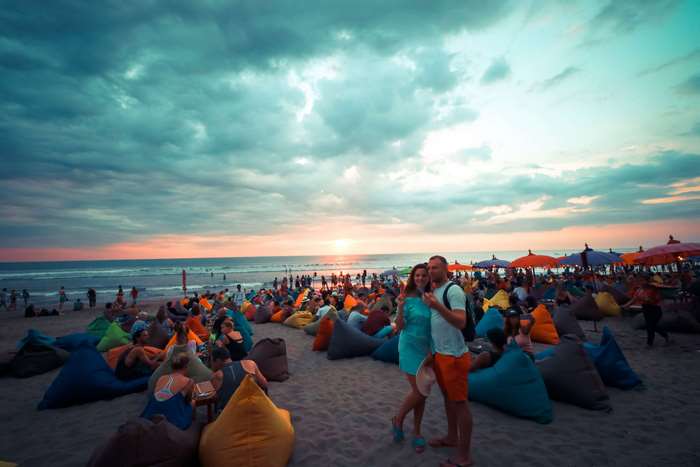 Couple on beanbags at a beach party in Bali
