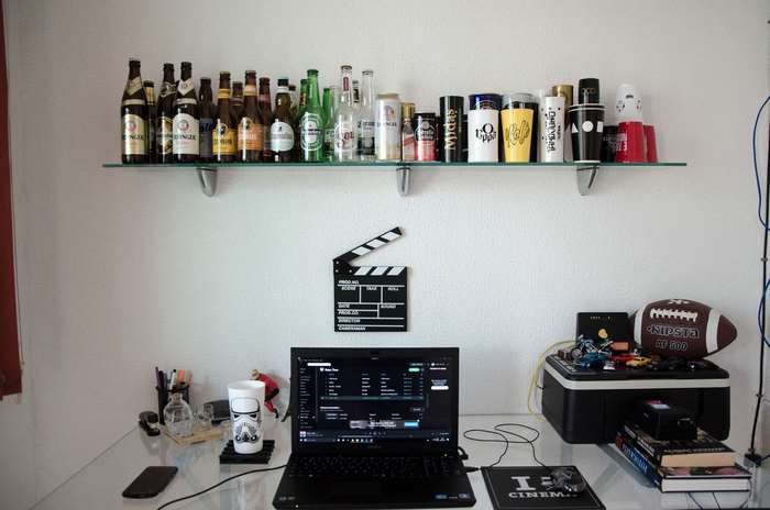 Home office with laptop and shelf of drinks