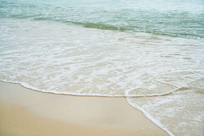 Ocean waves washing onto a sandy beach