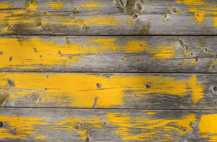 Weathered wood planks with peeling yellow paint texture 4K