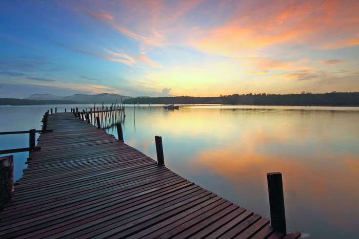 Wooden dock on a lake at sunset