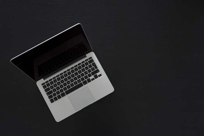 MacBook Pro laptop on a black surface