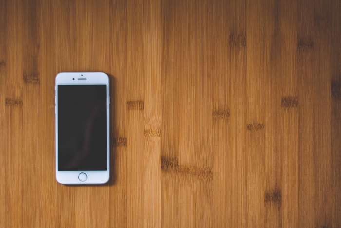 White iPhone on a wooden surface
