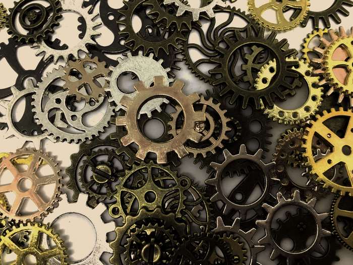 Abstract arrangement of various metal gears and cogs