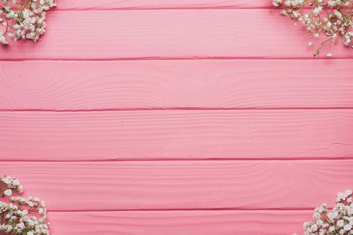 Delicate White Flowers on Pink Wooden Background