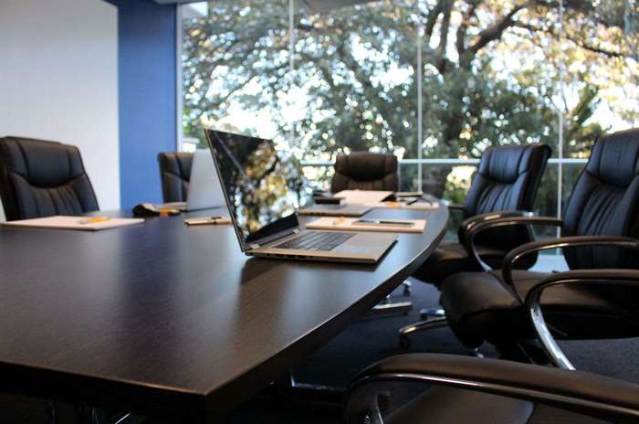 Boardroom with chairs and laptop on table