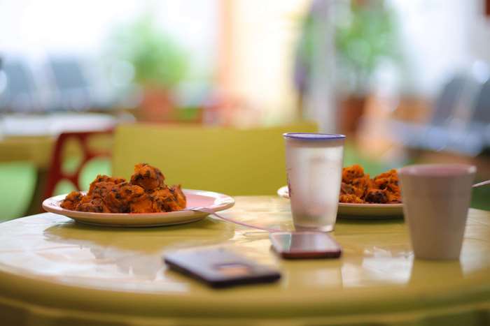 Food on a table with phones and drinks