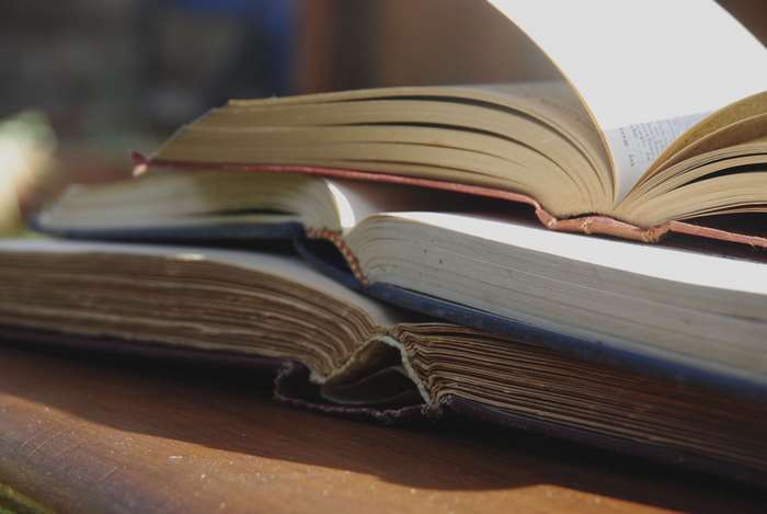 Stack of old open books 4K
