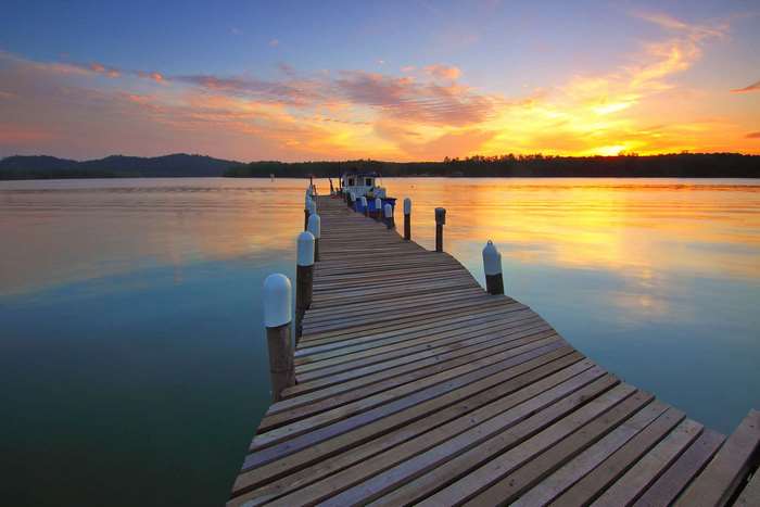 Wooden dock on a lake at sunset