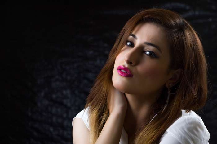 Woman with pink lipstick and brown hair