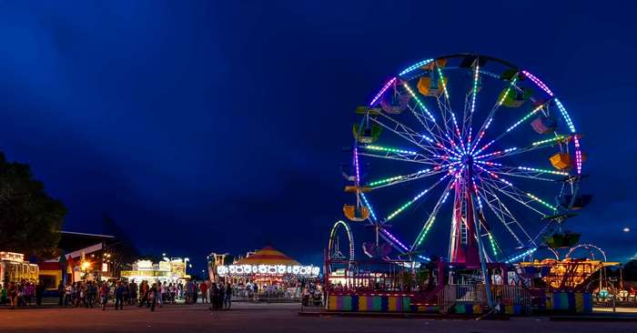 Ferris wheel and rides at a night fair
