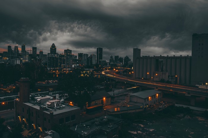 Montreal cityscape at night under stormy clouds