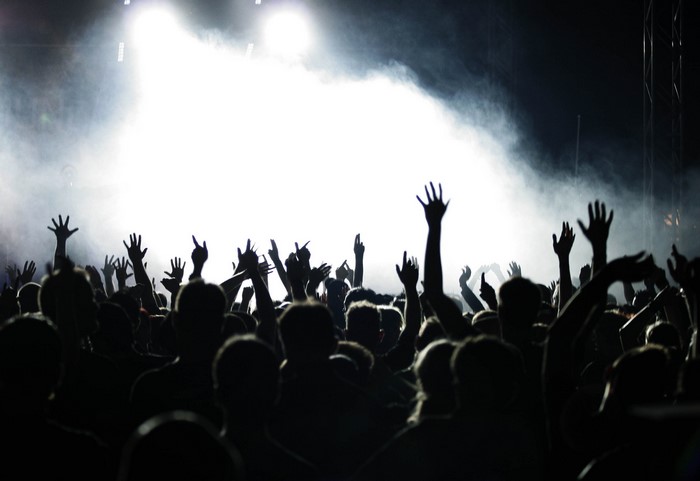 Crowd with hands raised at a concert