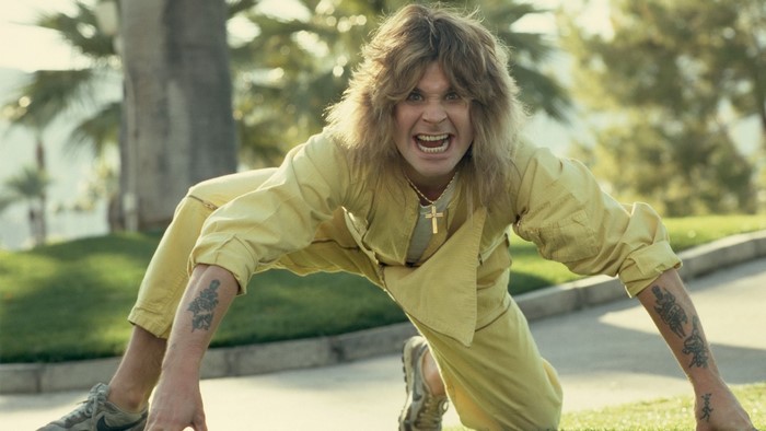 Ozzy Osbourne in yellow jumpsuit with tattoos