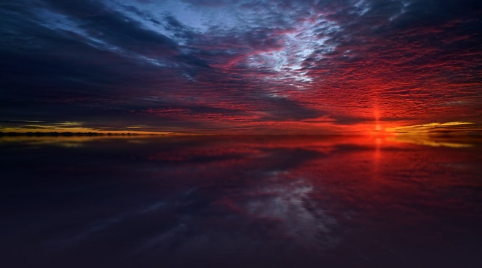 Dramatic Twilight Sunset Over Reflective Sea