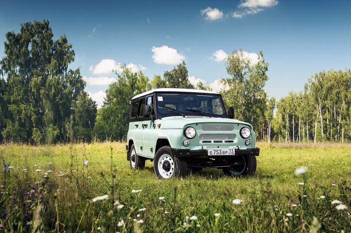 UAZ Hunter off-road vehicle in a grassy field