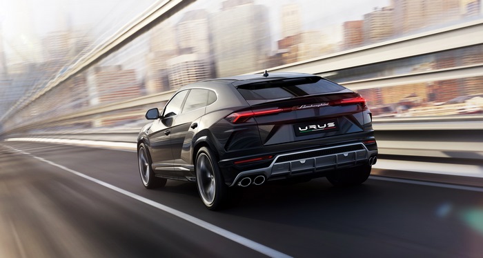 Black Lamborghini Urus driving on a highway