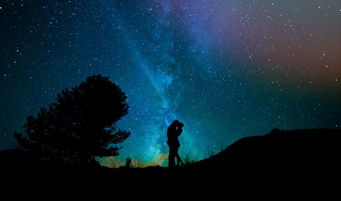 Couple kissing under the Milky Way 4K