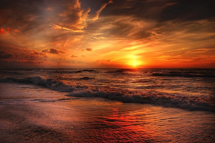 Serene Beach Sunset Over Calm Ocean Waves