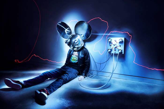 Deadmau5 sits connected to a wall panel