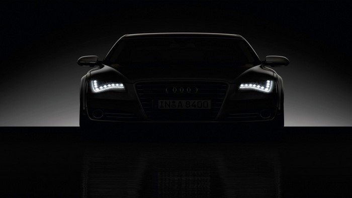 Audi A8 sedan with illuminated headlights