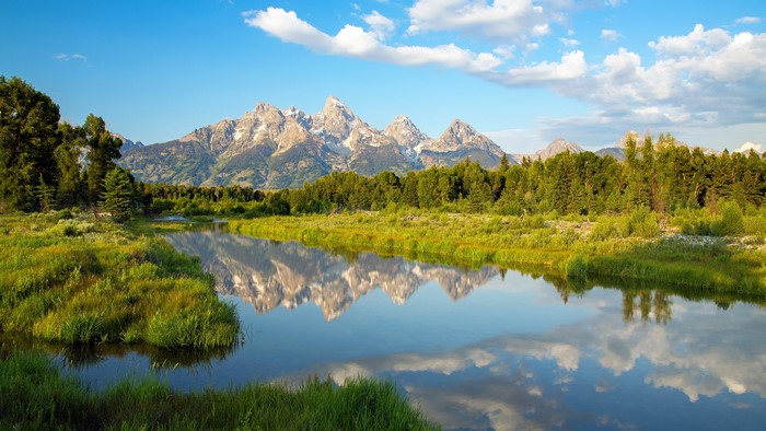 Mountains reflected in a river at sunrise