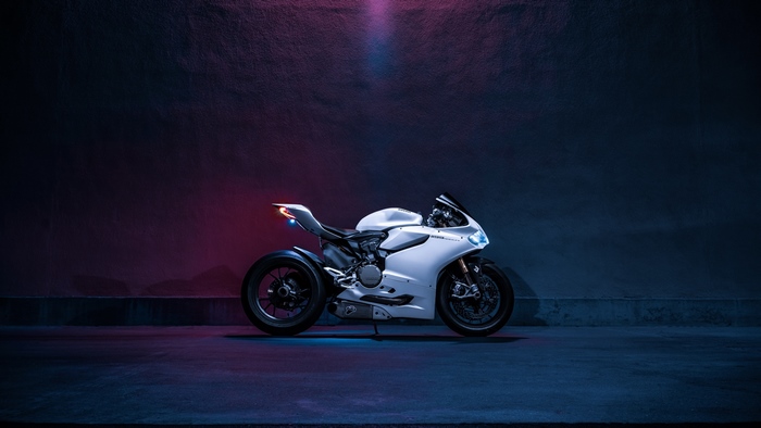 White Ducati Panigale motorcycle on dark background