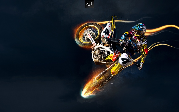 Motocross rider performing a stunt on a Suzuki bike