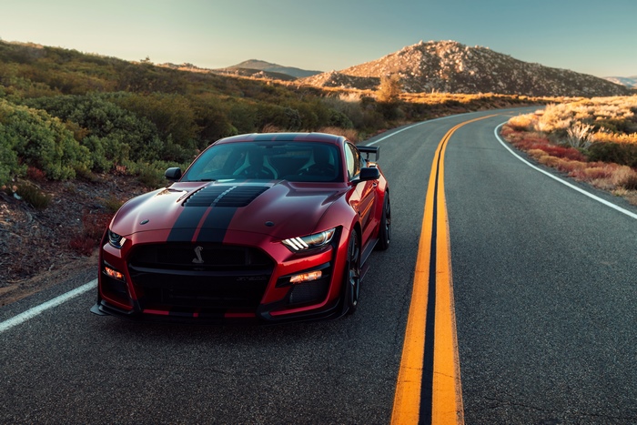 Red Ford Mustang Shelby GT500 on a winding road