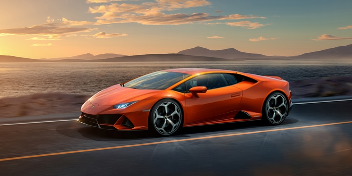 Orange Lamborghini Huracan Evo driving on road