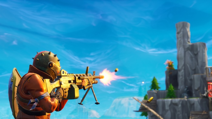 Fortnite character firing a golden machine gun