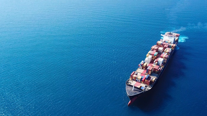 Container ship sailing on a blue ocean