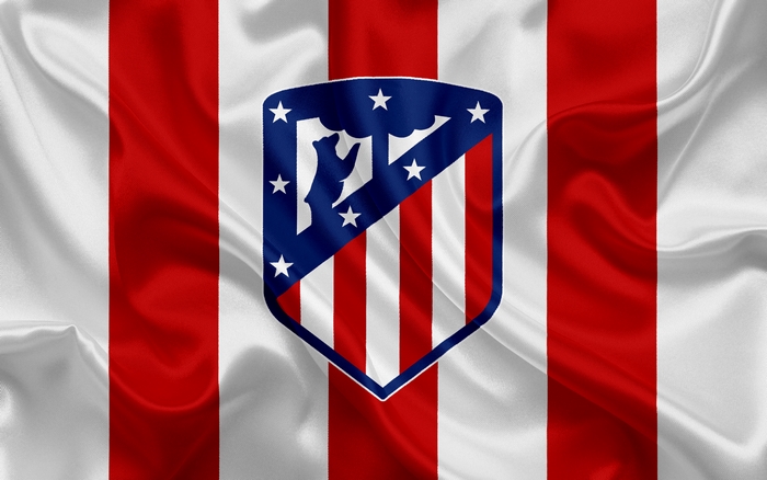 Atlético Madrid logo on a red and white striped flag