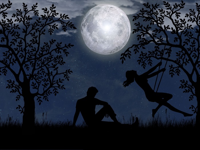 Couple on a swing under the full moon