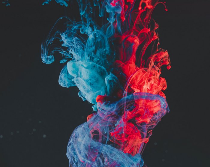 Red and blue ink swirling in water