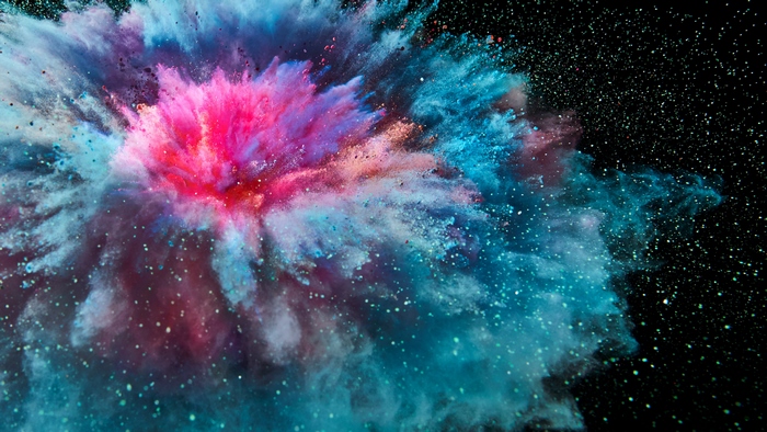 Explosion of colorful powder against a black background