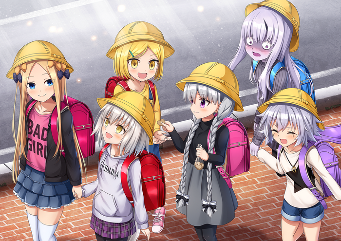 Children with backpacks and hats walking