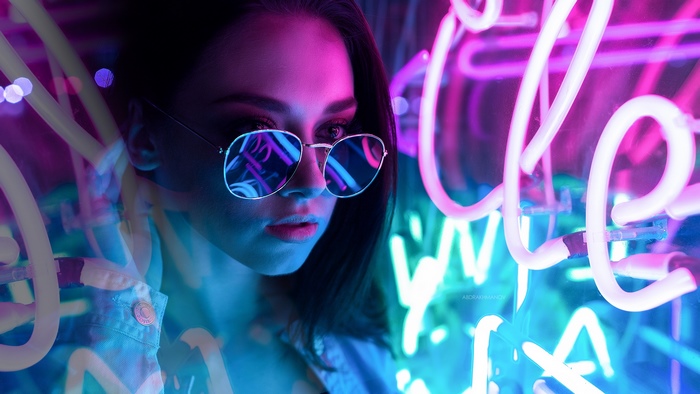 Woman wearing sunglasses with neon lights