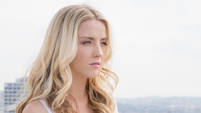 Woman with blonde hair looking to the side