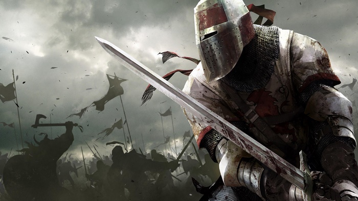 Knight in armor with sword on battlefield
