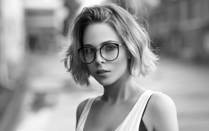 Woman with short hair and glasses