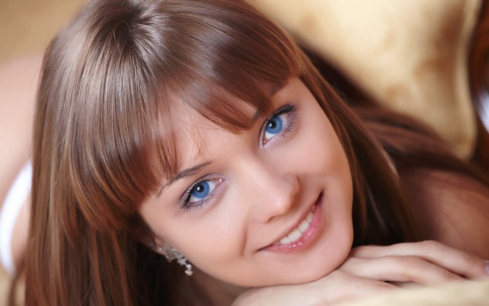 Close-up of Smiling Woman with Blue Eyes