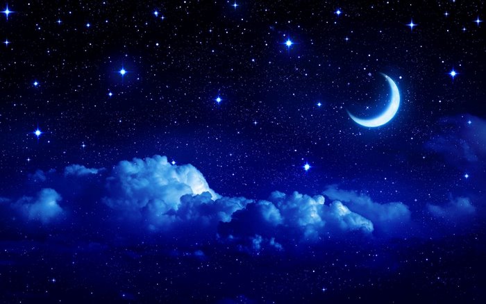 Crescent moon in a starry night sky with clouds